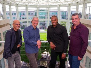 Beats cofounders Jimmy Iovine (left) and Dr. Dre (second from right) pose with Apple CEO TIm Cook and SVP Eddy Cue (right).