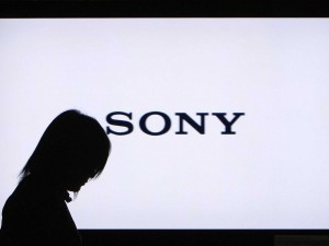 A woman walks past a Sony Corp flat-screen TV at the company's headquarters in Tokyo January 22, 2009